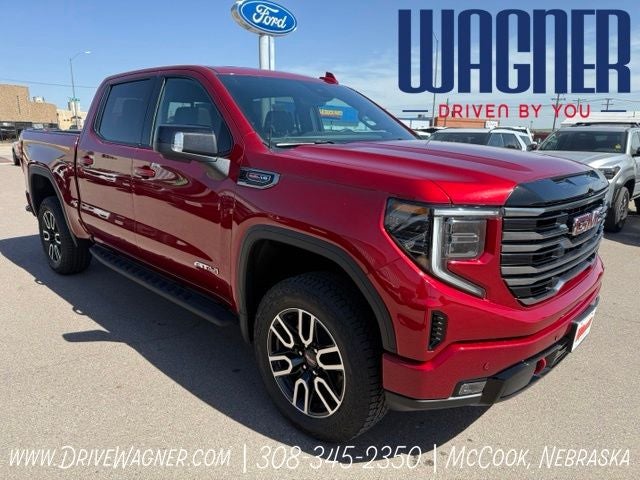 2026 GMC Sierra 1500 AT4 in Volcanic Red Tintcoat — front three-quarter view
